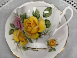 Detailed inspection of a vintage bone china teacup's body to identify hairline cracks and structural damage