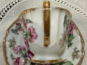 Close-up of a vintage porcelain teacup handle showing natural gilt wear and gold leaf aging for condition assessment