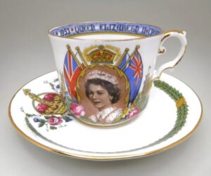 An Aynsley commemorative bone china teacup and saucer from the 1953 coronation of Queen Elizabeth II, featuring a detailed profile portrait of the Queen